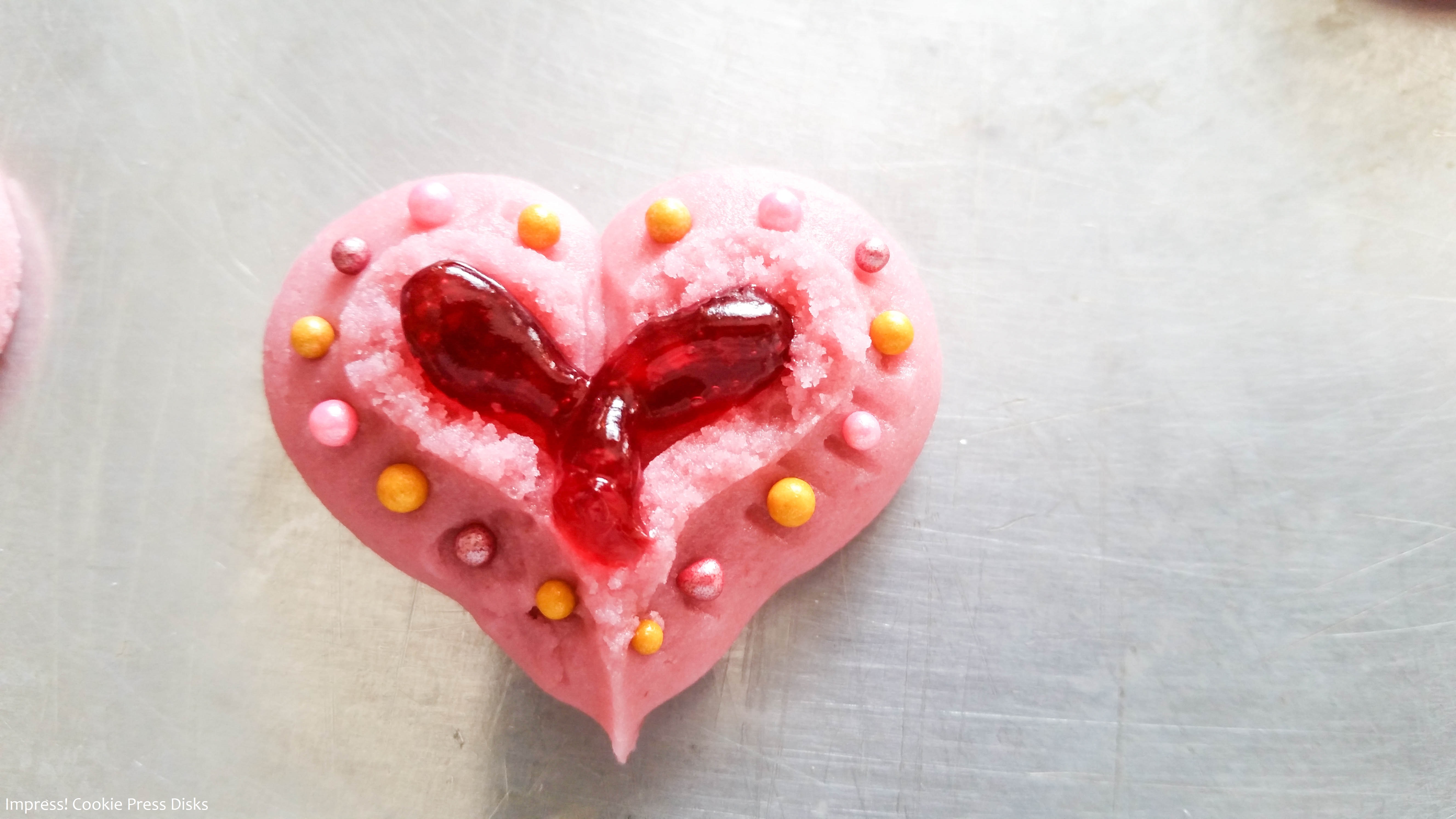 kk Raspberry Thumbprint Valentine’s Spritz Cookies cookie press w © 2018 Impress! Bakeware, LLC.jpg